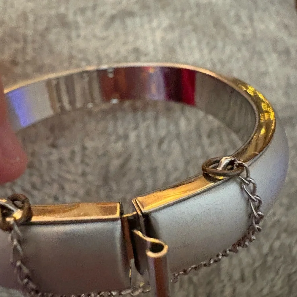 GUC silver tone bangle with safety chain
